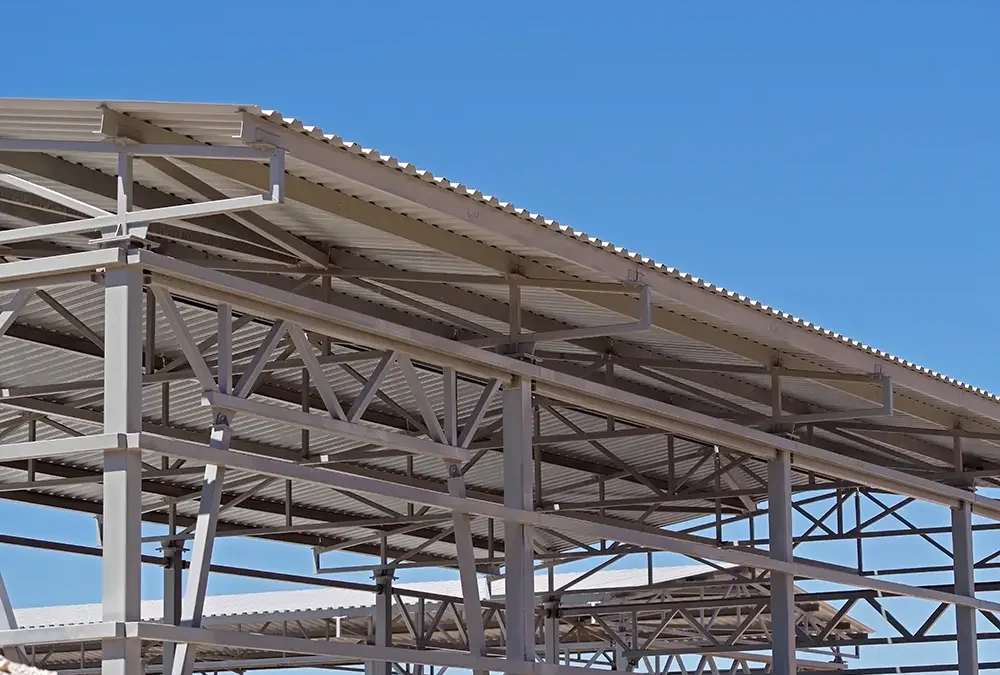 Metal purlin roof with steel framing and corrugated roofing panels on a commercial building.